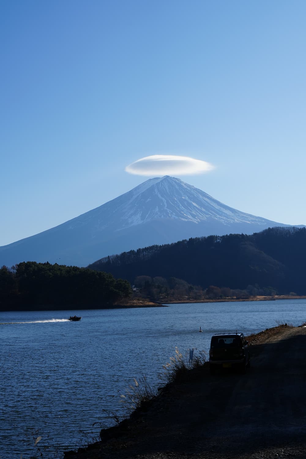 Mount Fuji under a lenticular cloud, seen across a lake